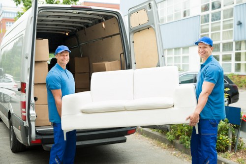 A man and van removal team loading furniture for a London move
