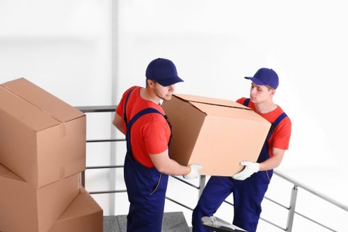 London removal crew loading furniture into a van for transport