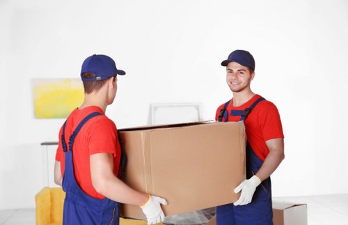 Boxes and household items being loaded into a removal van for a London move