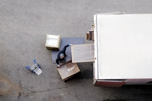 Moving crew handling desks and office furniture in a London building