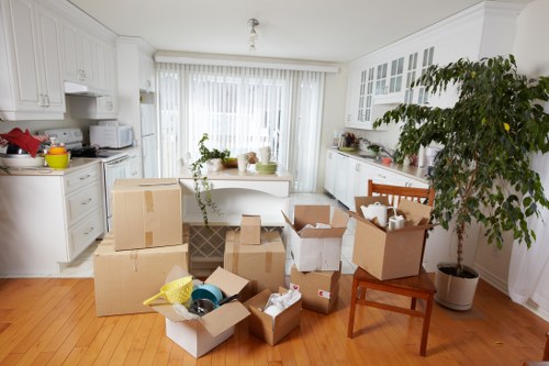 Packed boxes and furniture being loaded into a moving van in London