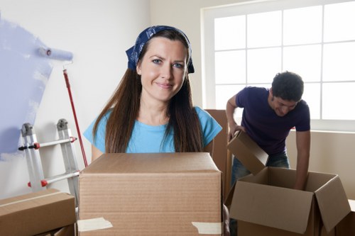 Removal team planning a London house move with boxes and furniture